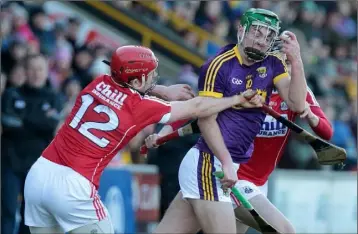  ??  ?? Wexford’s Aidan Nolan wins the ball from Bill Cooper of Cork.