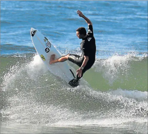  ??  ?? CATCHING A WAVE: Jean-Paul Veaudry in action at Eastern Beach