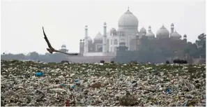  ?? — Reuters ?? Garbage is seen on the polluted banks of the river Yamuna near the historic Taj Mahal in Agra, India.