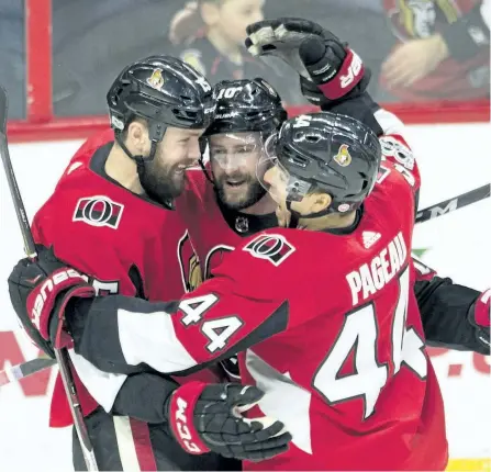  ?? ADRIAN WYLD/THE CANADIAN PRESS ?? Ottawa Senators left wing Zack Smith, left, celebrates his goal with left wing Tom Pyatt and centre Jean-Gabriel Pageau, right, celebrate a goal during third period NHL action in Ottawa, on Wednesday.