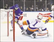  ?? Bruce Bennett / Getty Images ?? Islanders goalie Thomas Greiss makes a second-period save on the Rangers’ Brett Howden at Madison Square Garden on Tuesday.