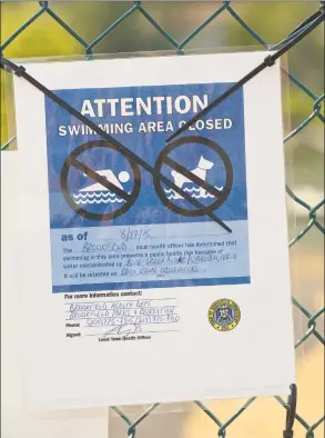  ?? Hearst Connecticu­t Media file photos ?? A notice on a gate to the Brookfield town beach informs visitors that town officials closed the beach until further notice in August 2015 after the discovery of what appeared to be bluegreen algae.