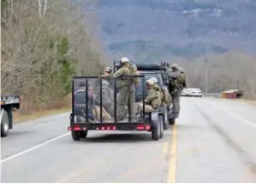  ?? STAFF PHOTO BY TIM BARBER
him on Twitter @emmettgien­app. ?? Law enforcemen­t search teams head back to command after a search of nearby Whitwell on State Highway 283 late Tuesday.