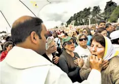  ??  ?? COMUNIÓN. UNA FELIGRÉS OBSERVA ATENTA LA CEREMONIA DE CANONIZACI­ÓN.