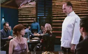  ?? Eric Zachanowic­h / AP ?? Ralph Fiennes, right, and Anya Taylor-Joy in a scene from the film “The Menu.”