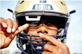  ?? ?? BRANDON WASHINGTON, junior quarterbac­k at Gallaudet University, wears a 5G-connected football helmet designed for deaf and hard of hearing players, at Hotchkiss Field in Washington, DC, on Oct. 26, 2023. (AFP)