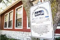  ?? Star-Telegram via AP ?? A sign describing the history of the Mosier Valley Schoolhous­e hangs outside the Studio 2020 salon on Aug. 11 in Bedford, Texas.