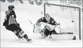  ?? Jae C. Hong Associated Press ?? CENTER Adam Henrique scores the shootout winner for the Ducks against Winnipeg Jets goaltender Connor Hellebuyck.