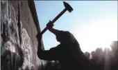  ?? PICTURE: AP ?? A man hammers at the Berlin Wall, the border barrier between East and West Germany.