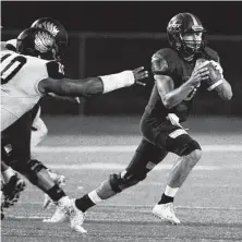  ?? Eric Christian Smith / Contributo­r ?? Magnolia West quarterbac­k Jon Matocha, right, avoids the Foster pass rush in the first half of the Mustangs’ win Friday.