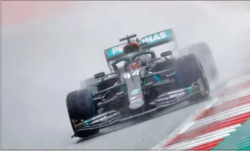  ?? AFP ?? Lewis Hamilton of Mercedes delivered one of his greatest qualifying performanc­es in rain-swept conditions to capture the pole position at the Styrian Grand Prix on Saturday.