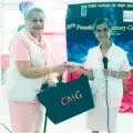  ?? ?? TOKEN.
Catholic Volunteers for Charity Movement foundress Madam Socorro Valencia (left), receiving a token of appreciati­on from Dr. Nancy Bayani.