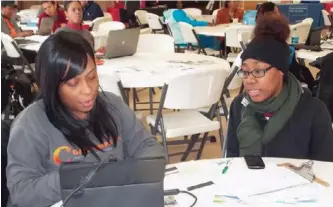  ??  ?? April Caldwell, 19, successful­ly enrolls at a Get Covered America healthcare enrollment event at the Allen Metropolit­an CME church in Chicago.