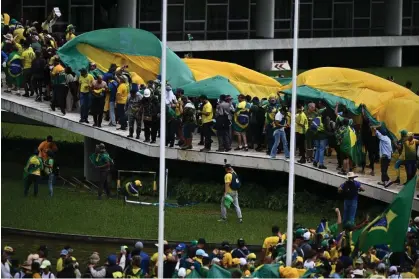  ?? Photograph: Andre Borges/EPA ?? Bolsonaro supporters storm the National Congress in the Brazilian capital Brasília this month.