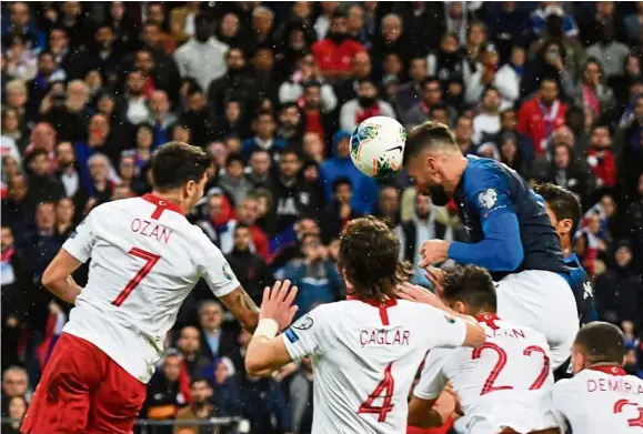  ?? — AFP ?? Going in: France’s Olivier Giroud (right) heading home during the Euro 2020 Group H qualifying match against Turkey at the Stade de France in Paris on Monday.
