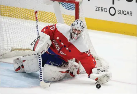  ?? The Canadian Press ?? Washington Capitals goaltender Braden Holtby reaches for the puck during the third period of an NHL game against the Pittsburgh Penguins in Washington on Feb. 23. The Vancouver Canucks signed Holtby to an $8.6 million, two-year deal on Friday.