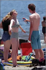  ?? DAN COYRO — STAFF ARCHIVES ?? Beachgoers in Capitola break out the sunblock as temperatur­es pushed into the 90s along the Central Coast last month.