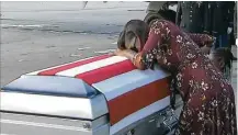  ?? WPLG via AP ?? Myeshia Johnson cries over the casket of her husband, Sgt. La David Johnson. The president denies making offensive remarks to the soldier’s family.