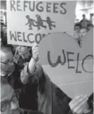  ??  ?? Well-wishers hold up handwritte­n signs to w station in Dortmund, Germany, this week.