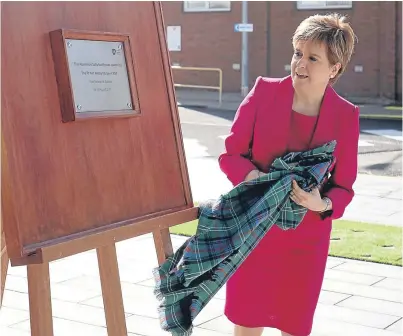  ?? Picture: Getty Images. ?? First Minister Nicola Sturgeon unveils a plaque during a visit to GlaxoSmith­Kline in Montrose, where she opened their new £44 million aluminium salts facility.