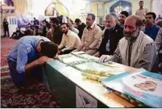  ?? Reuters ?? Mourners gather around the bodies of Iranians killed in Syria, during their funeral in the city of Mashad on Wednesday.