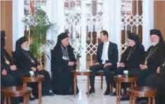  ??  ?? DAMASCUS: Syrian President Bashar Al-Assad (center right) meets the new Melkite Greek Catholic Patriarch Youssef Absi (center left) in Damascus. — AFP