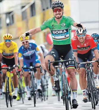  ?? CHRISTOPHE ENA THE ASSOCIATED PRESS ?? Slovakia’s Peter Sagan, wearing the best sprinter’s green jersey, crosses the finish line to win the fifth stage of the Tour de France cycling race in Quimper, France, on Wednesday.