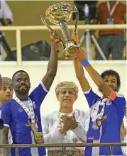  ??  ?? Al Nasr captain Abdullah al Nouh (right) and Fahad Naseeb hold the trophy