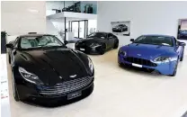  ??  ?? ASTON MARTIN sports cars are seen in a showroom of Swiss Emil Frey AG in Safenwil, Switzerlan­d, May 31.