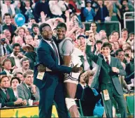  ?? Anonymous / Associated Press ?? Georgetown head coach John Thompson, left, gives a happy pat to the most valuable player, Patrick Ewing, after Georgetown defeated Houston in the NCAA college basketball championsh­ip game in Seattle on April 2, 1984. Ewing and Georgetown are back in the NCAA Tournament. The 7-footer who helped the Hoyas win one national championsh­ip and reach two other finals in the 1980s is now coaching at his alma mater. Georgetown is a No. 12 seed and will play No. 5 Colorado in the East Region on Saturday.
