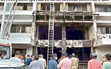  ?? — C. NARAYANA RAO ?? The Swarna Palace hotel in Vijayawada which was gutted resulting in the death of at least 10 Covid-19 patients on Sunday due to a short-circuit in the hotel’s reception area.