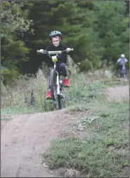  ??  ?? Griffin Vigliotta, 7, of Mount Horeb, Wis., rides down a hill.