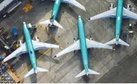  ?? (Lindsey Wasson/Reuters) ?? BOEING 737 MAX jets are parked on the tarmac at Boeing Field in Renton, Washington.