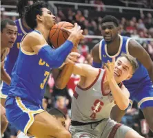  ?? Tony Avelar / Associated Press ?? UCLA guard Jules Bernard (3) battles for a loose ball against Stanford guard Isaac White in the first half.