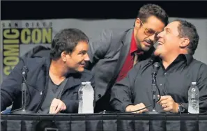  ?? By Kevin Winter, Getty Images ?? In theaters in May 2013: Iron Man 3 director Shane Black, left, and actors Robert Downey Jr. and Jon Favreau joke around at Marvel Studios’ Comic-Con panel Saturday.