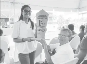  ?? ?? Sister Marie Harper and a Marian Academy student with the 2023 Environmen­tal Protection Agency winning trophy for best chant during the Environmen­tal Walk
