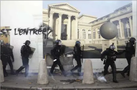  ?? PHOTOS BY KAMIL ZIHNIOGLU — THE ASSOCIATED PRESS ?? Riot police take positions Saturday along a fence showing the renovation project of the National Assembly during clashes with yellow vest protesters in Paris.