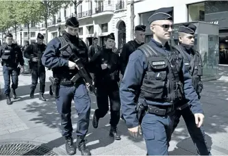  ?? PHILIPPE LOPEZ/GETTY IMAGES ?? Police officers patrol the Champs Elysees in Paris on Friday a day after a gunman opened fire on police on the avenue, killing a policeman and wounding two others in an attack claimed by Islamic State.