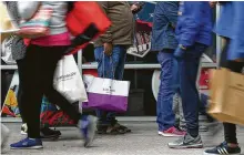  ?? Godofredo A. Vasquez / Staff photograph­er ?? People wait in line to enter the Tory Burch store for Black Friday sales at the Houston Premium Outlets on Nov. 23.