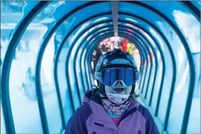  ?? (AP/Bozeman Daily Chronicle/Samuel Wilson) ?? Eagle Mount participan­t Raechel Raether smiles Dec. 29 as she rides a carpet lift during a ski lesson at Big Sky Resort in Big Sky, Mont.