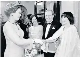  ??  ?? Hardy (above) as Winston Churchill in The Woman
He Loved (1988) with Anthony Andrews as Edward VIII; and, right, meeting the Queen with Leslie Caron and Mireille Mathieu at a royal performanc­e of Moulin Rouge in 1983