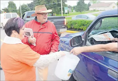  ?? MITCH MACDONALD/TC MEDIA ?? Best Start Kings County worker Stacey Newell and Montague-Kilmuir MLA Allen Roach hard at work raising funds for literacy in Montague during the Raise-a-Reader campaign.