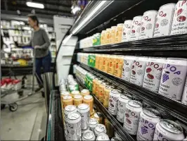  ?? MIKE STEWART/ASSOCIATED PRESS ?? Cans of Olipop, a drink containing botanicals, plant fibers and prebiotics, are displayed at a supermarke­t in Marietta. The rush of functional beverages, touted for their health benefits, has grown into a multibilli­on-dollar industry.