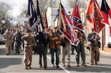  ?? Saul Loeb — AFP photos by Ryan M. Kelly and ?? Confederat­e re-enactors and supporters march through Lexington, Virginia, during Lee-Jackson Day celebratio­ns.