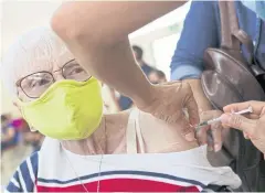  ?? REUTERS ?? An elderly woman receives the first dose of the Pfizer-BioNTech coronaviru­s disease vaccine, in San Jose, Costa Rica on Wednesday.