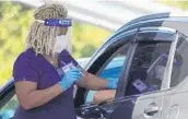  ?? JOE CAVARETTA/SOUTH FLORIDA SUN SENTINEL PHOTOS ?? A COVID-19 vaccine is given at Snyder Park on Tuesday.