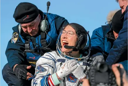  ?? AP ?? US astronaut Christina Koch reacts shortly after the landing of the Russian Soyuz MS-13 space capsule about 150km south-east of the Kazakh town of Zhezkazgan.