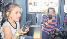  ?? FRAM DINSHAW/ TRURO NEWS ?? Firefighte­rs’ radio sets are trickier to use than the average walkie talkie, as Myla Wyle, and her brother, Jett, learned.