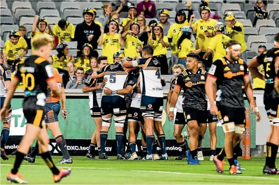  ??  ?? As Brumbies players and fans celebrate one of their eight tries, Chiefs players reflect on a dismal outing that left coach Colin Cooper ‘‘speechless’’.