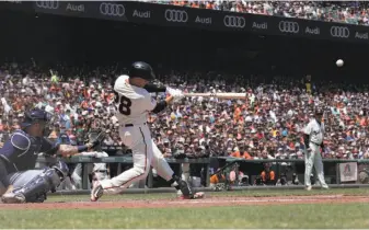  ?? Carlos Avila Gonzalez / The Chronicle ?? Buster Posey hits a three-run double in the third inning to give the Giants the lead, the first of his four hits on the day. His last four-hit game was Sept. 15, 2016, against St. Louis at home.